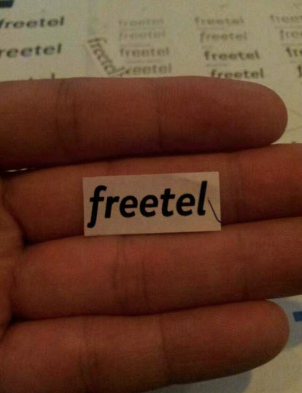 手のひらに載せて見え方を確認したfreetelの紙ロゴ